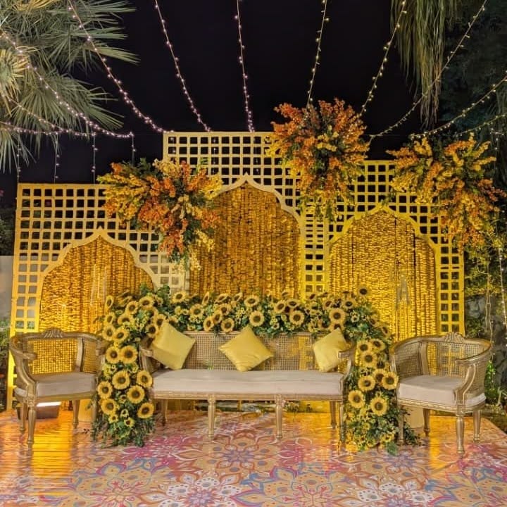 A wide courtyard shot showing the full seating layout in dappled shade