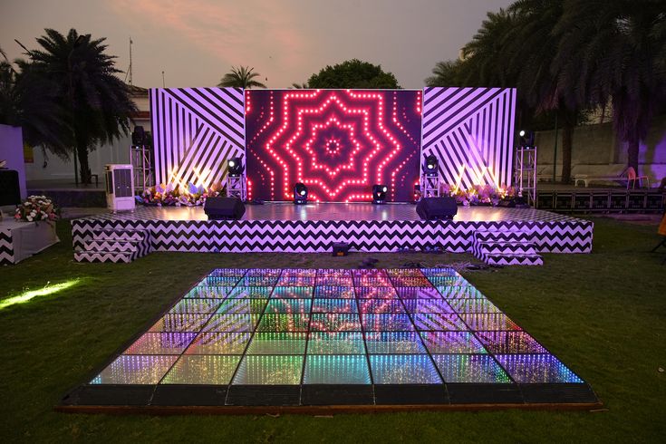 A stage mid-performance, warm par-can lighting, dancers in motion