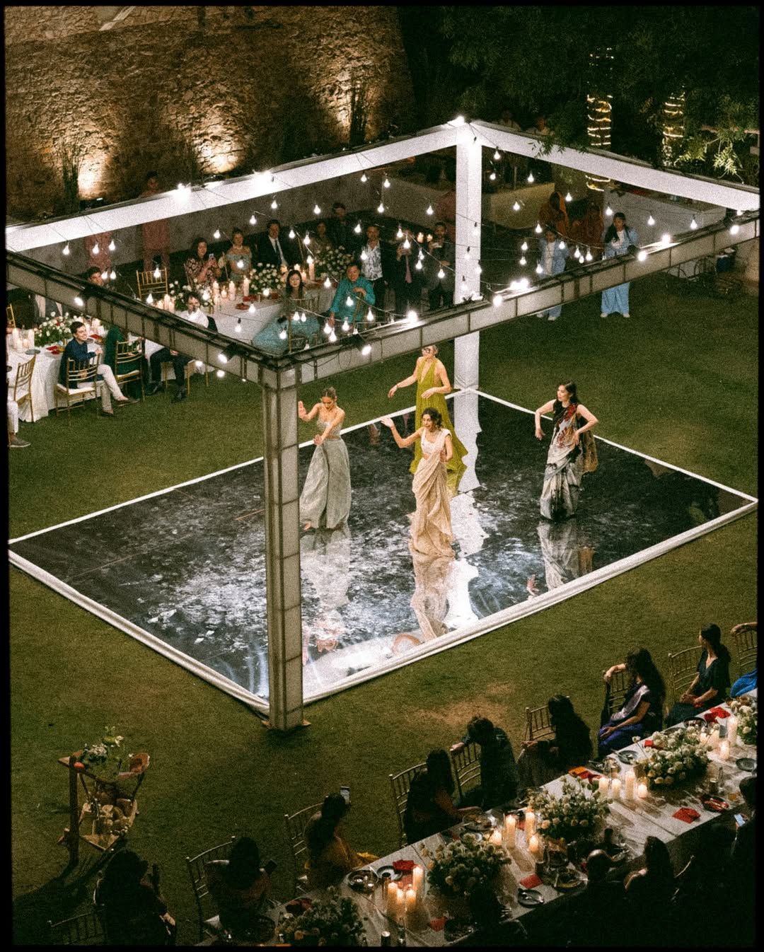 An elegant stage adorned with vibrant florals and festive details
